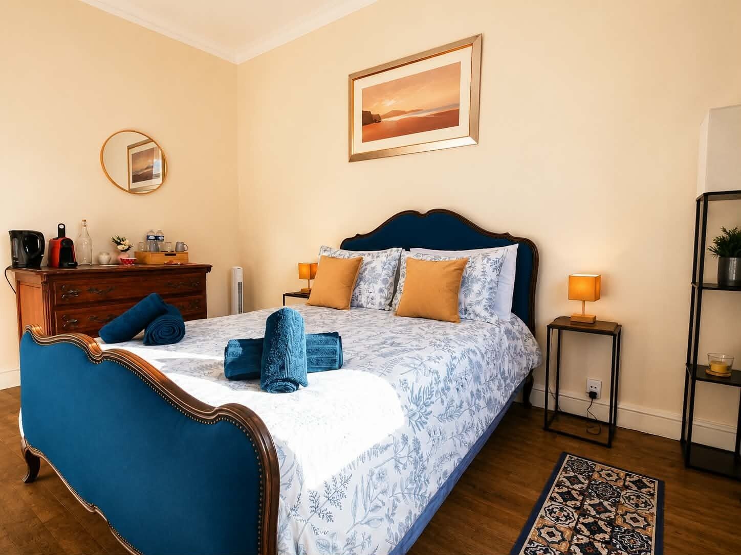Un dormitorio con cama, cómoda, mesitas de noche y alfombra.