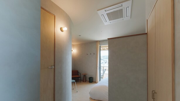 A bedroom with a bed, a wardrobe, a desk, and a chair. - cuccou (Aira)