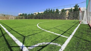 A soccer field with goalposts, a net, and a fence. - Atlantica Mikri Poli Rhodes (Rhodes)