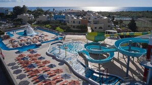 A resort with a large pool area, water slides, and a view of the sea. - Atlantica Mikri Poli Rhodes (Rhodes)