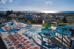 A resort with a large pool area, water slides, and a view of the sea. - Atlantica Mikri Poli Rhodes (Rhodes)