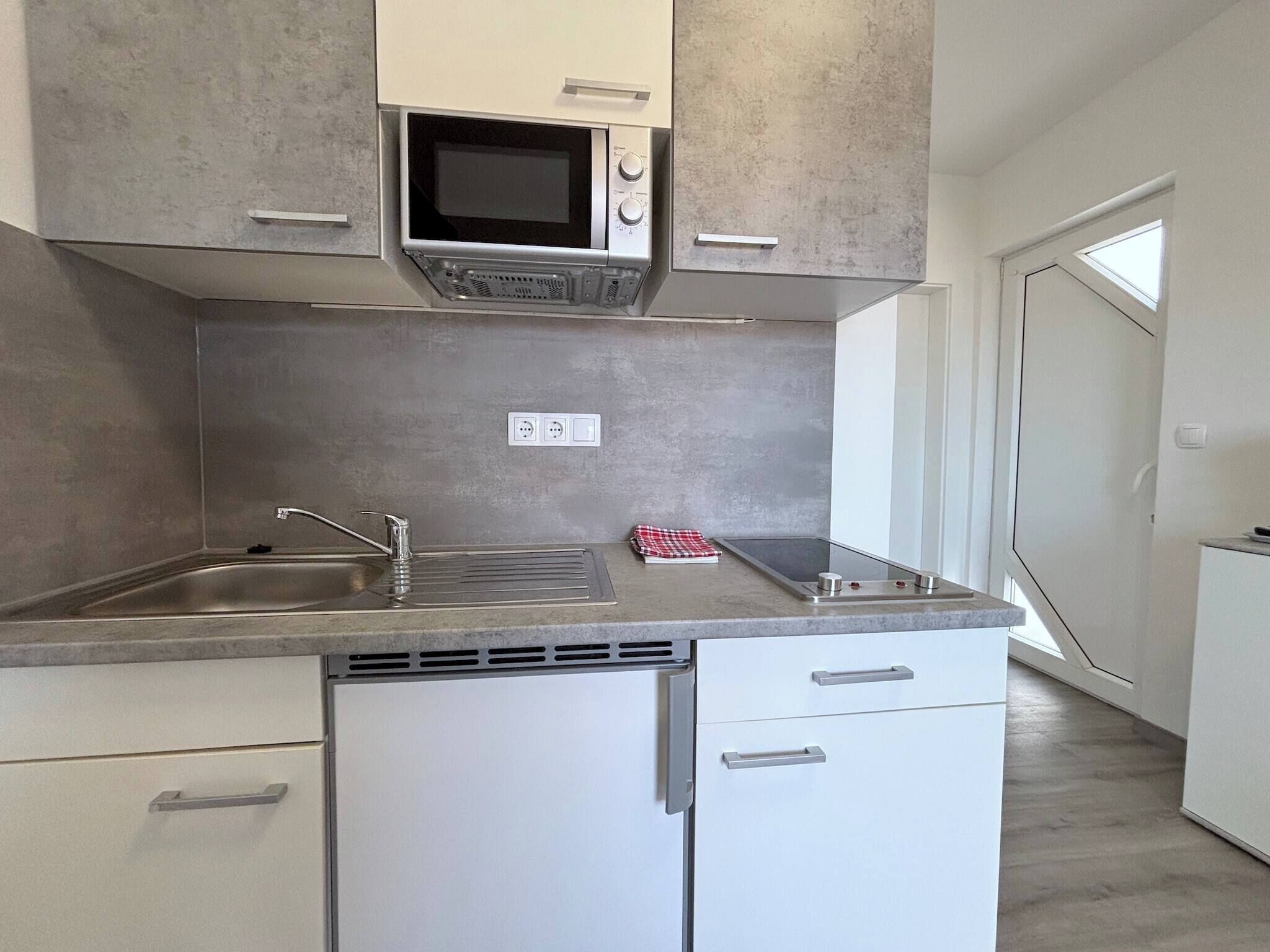 Fridge, microwave, coffee/tea maker, cookware/dishes/utensils