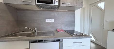 Fridge, microwave, coffee/tea maker, cookware/dishes/utensils