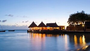 A beachfront property with overwater bungalows, calm water, and a clear sky. - Veranda Paul et Virginie Hotel and Spa - Adults Only (Grand Gaube)