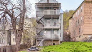 A multi-story building with a balcony on the second floor, a stone foundation, and a grassy yard. - 1 Mi to Erie Canalway Trail! Condo w/ Grill (Little Falls)