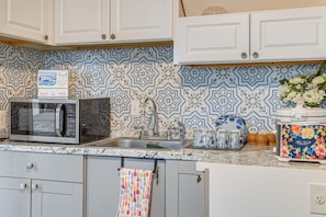 Fridge, microwave, coffee/tea maker, cookware/dishes/utensils