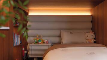 A cozy bedroom with a bed, bedside table, and a shelf with books and toys.