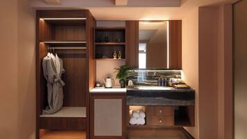 A modern bathroom with a built-in vanity, towel racks, and a large mirror.