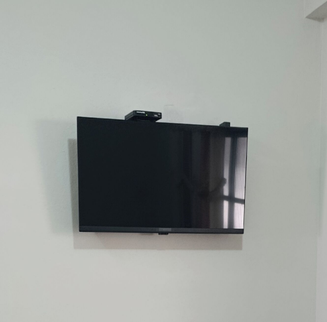 A flat-screen TV mounted on a plain wall.