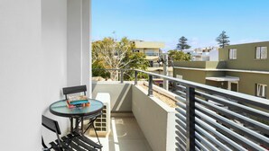 A balcony with a small table, chairs, and a few books. - Retreat Apartment in Rhodes Town (Rhodes)