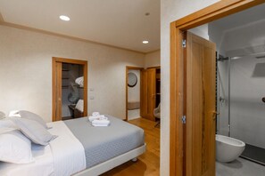 A bedroom with a bed, a wooden door, a bathroom with a toilet, and a shower. - Rivoli Gallery Residence (Verona)