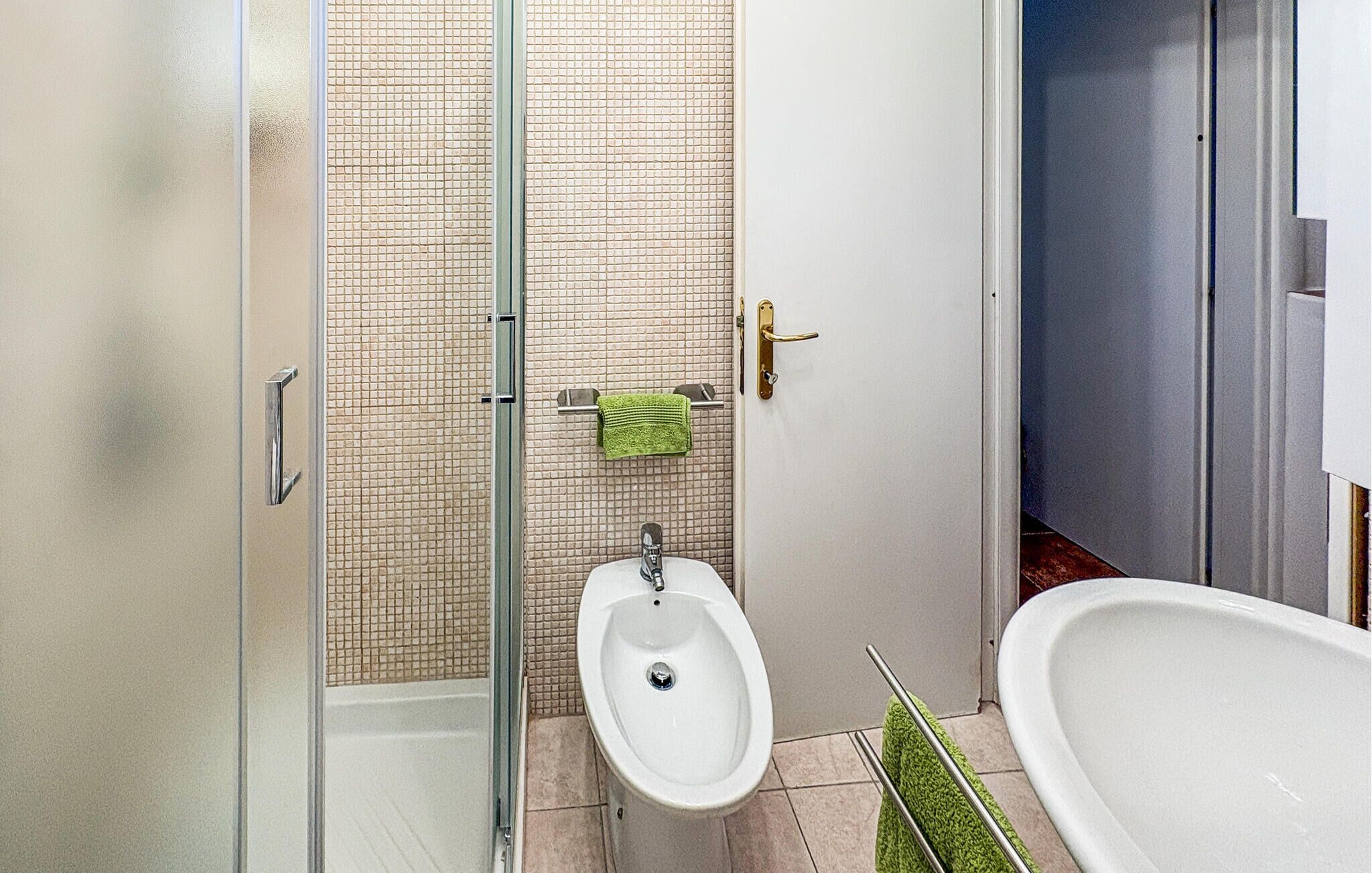 Une salle de bain équipée d’un bidet, d’une douche et d’une baignoire.