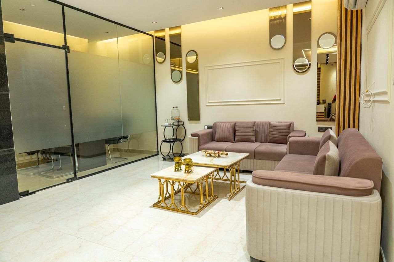 A modern living room with a sectional sofa, a coffee table, and a glass partition.