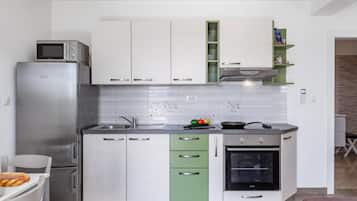 A modern kitchen with stainless steel appliances, a built-in oven, and a microwave.