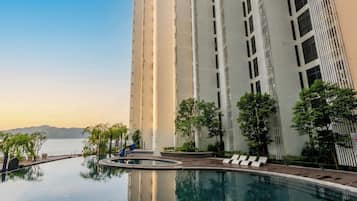 Outdoor pool, open 7:00 AM to 10:00 PM, pool loungers