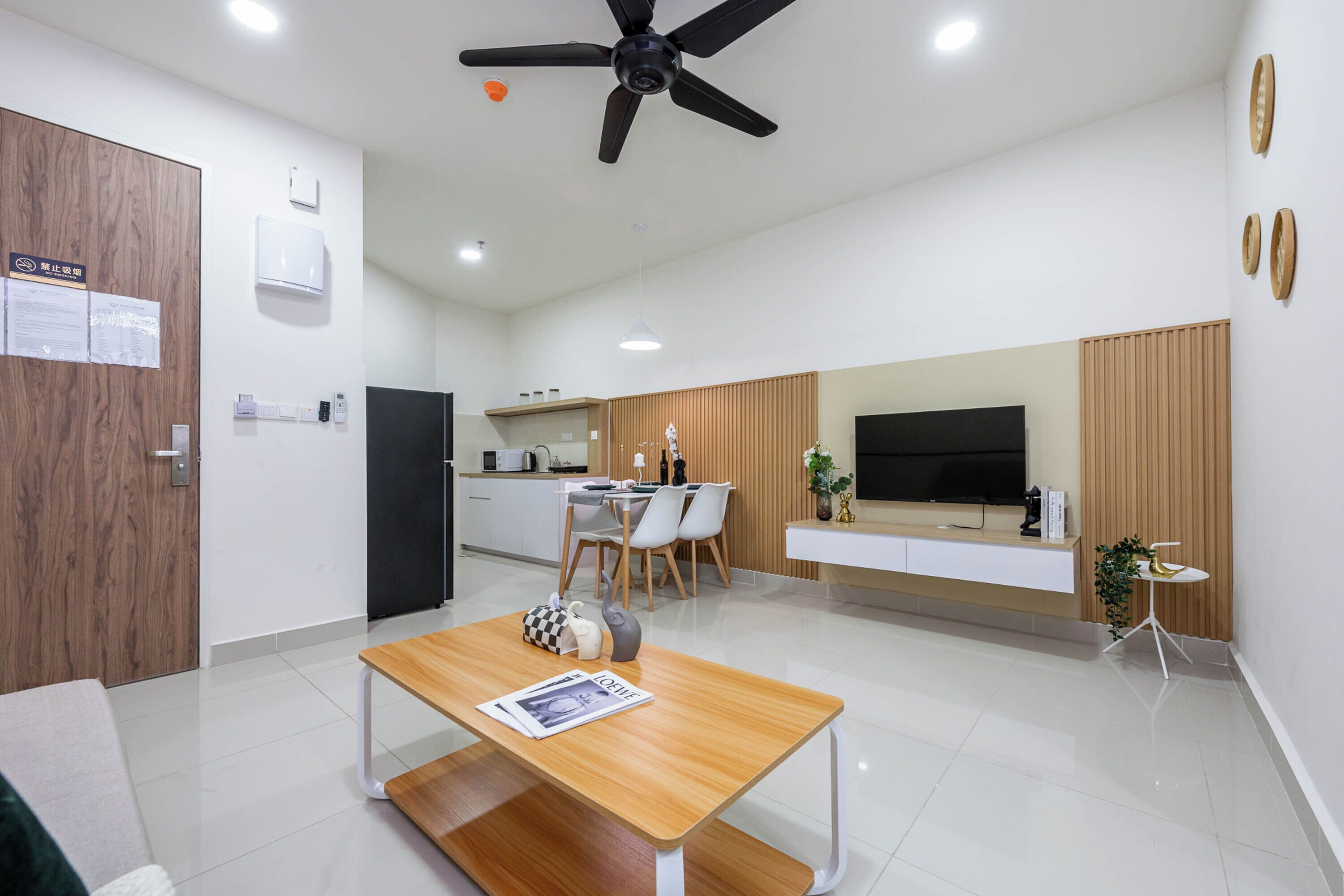 Una sala de estar moderna con una mesa de centro de madera, un televisor y un comedor con sillas y una mesa.