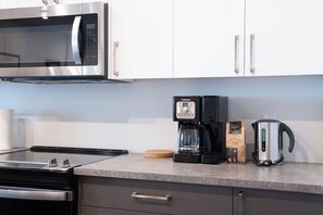 Fridge, microwave, oven, stovetop - Spacious Revelstoke rental near ski hill and downtown, with private hot tub, full kitchen, and comfortable living areas for up to 5 guests. (Revelstoke)