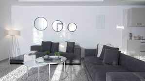 A modern living room with a grey sofa, a glass coffee table, and a floor lamp. There are three round mirrors on the wall and a small plant on the table. - sandra 11 (La Marsa)