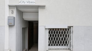 A building entrance with a sign reading 'City Vibes' and a mailbox. - City Vibes - 2-BR Apt. with Backyard in kolonaki (Athens)