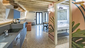 Une cuisine moderne dotée d’un plan de travail, de placards et d’un coin repas avec une table et des chaises.