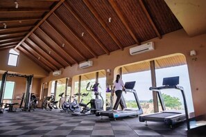 A gym with treadmills, stationary bikes, and weight machines.
