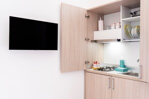 A kitchen with a built-in gas stove, a sink, and a microwave.