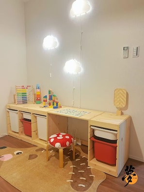 A child's play area with a wooden desk, storage bins, a red cushion, and a patterned rug. - Open Sale】 YUME Yume Matsuyacho 201 ｜Namba/Shinsaibashi area｜Walking distance from the station｜Family welcome (大阪市)