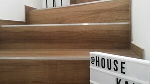 Un escalier en bois sur lequel est apposée une plaque indiquant « @HOUSE KALA #CROATIE ».
