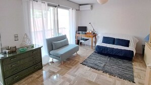 A bedroom with a bed, a sofa, a desk, and a dresser. - MONACO Fantastic seaview - 2 bedrooms- 110m² - AC (Roquebrune Cap Martin)