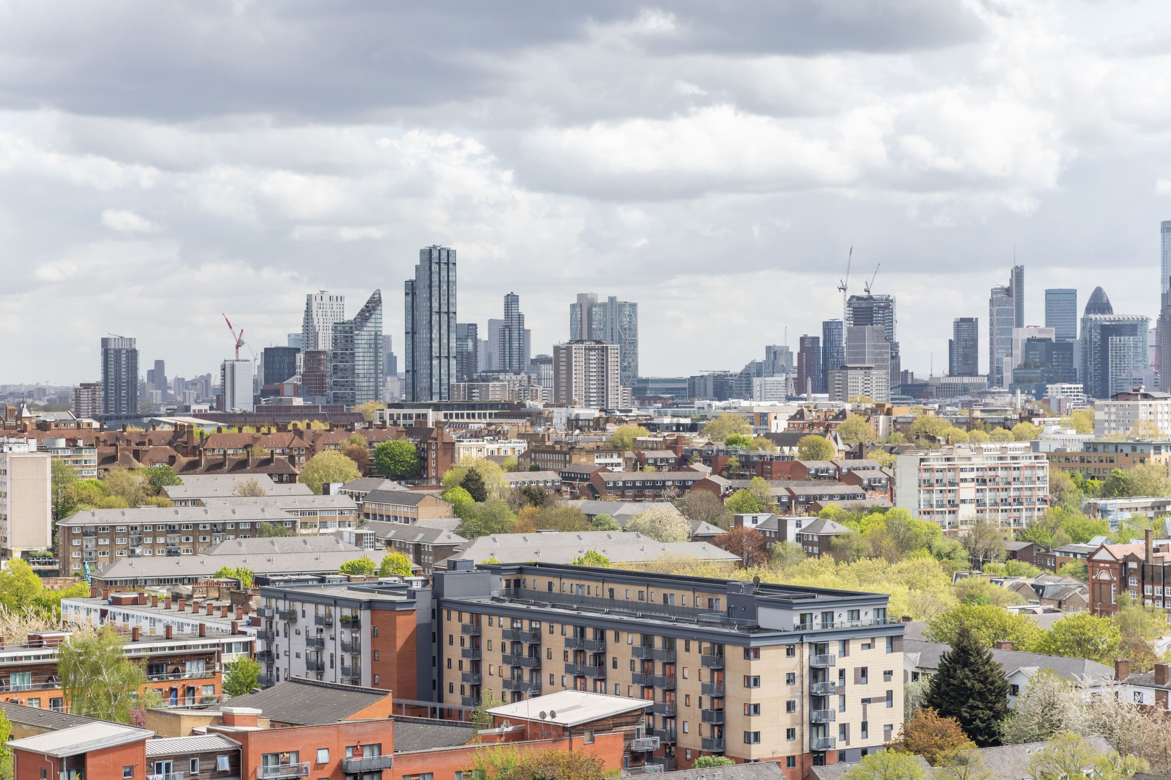 A cityscape with modern high-rise buildings, residential areas, and a mix of architectural styles.