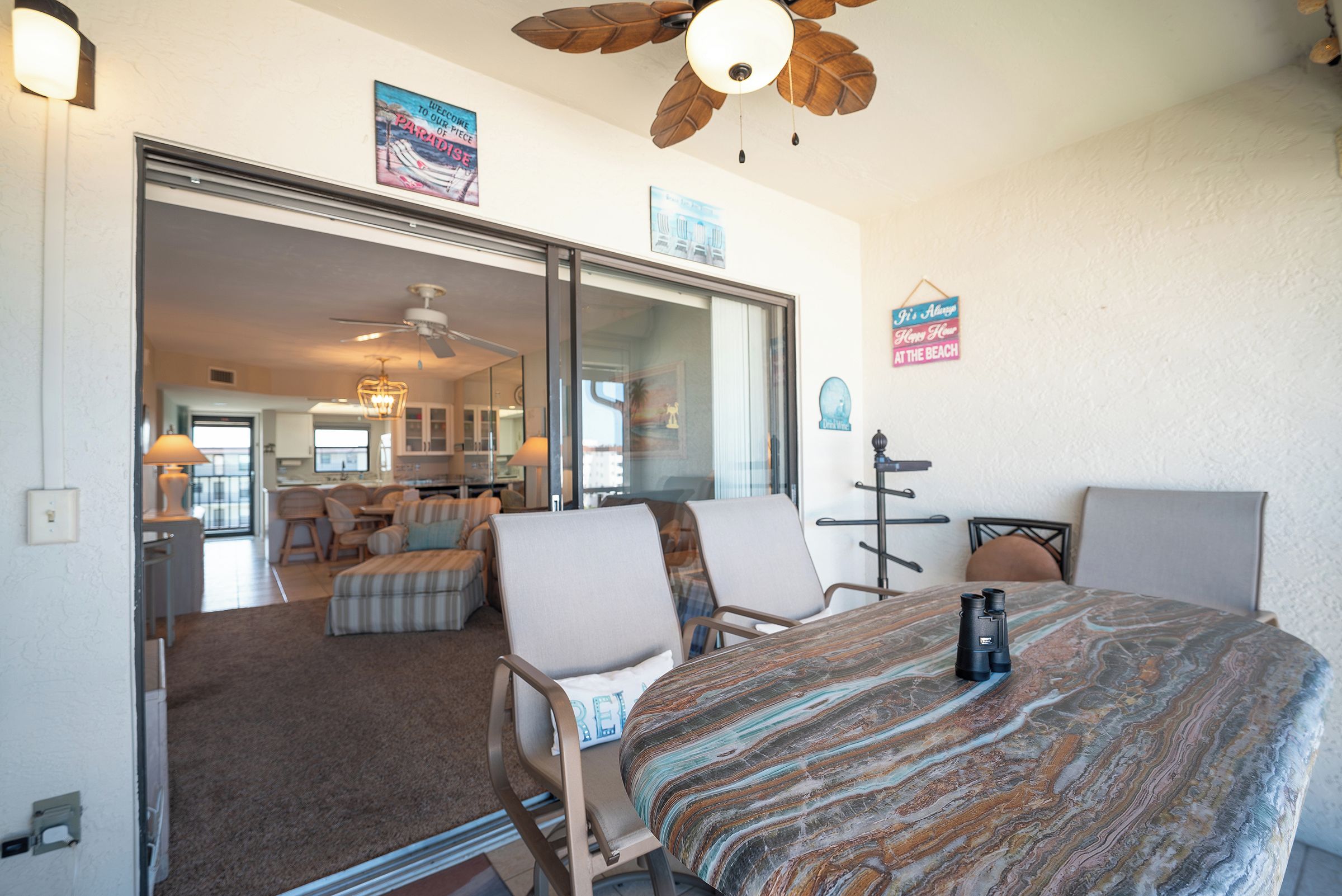 A hotel room with a bed, chairs, a desk, and a large mirror.