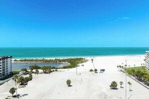 A beach view with a clear sky, a sandy beach, and a body of water. - Fun In Sun On A Budget! 2B/2B Condo w/ Pool & Tennis! Walk to Beach! EC163 (Fort Myers Beach)