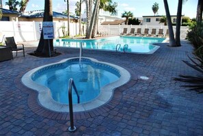 A swimming pool with a sign indicating a 50-person capacity. - ONE BEDROOM CONDO 1107 (San Diego)