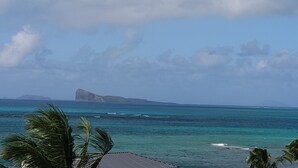 A coastal view with clear skies, ocean, and distant landmass. - Sublime Pointe aux Canonniers (Pointe aux Canonniers)