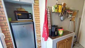 A compact kitchen with a microwave, refrigerator, and a coffee maker on the counter. - Lovely apartment with panoramic view - 6 guests (Canet-en-Roussillon)