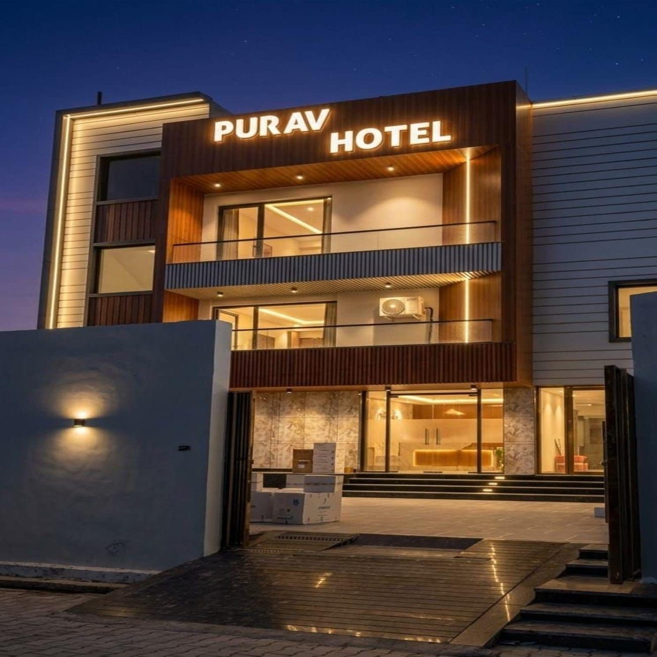 A modern hotel with a prominent sign reading 'PURAV HOTEL.'