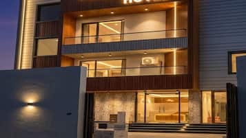 A modern hotel with a prominent sign reading 'PURAV HOTEL.'