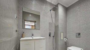 A modern bathroom with a large mirror, a vanity with a sink, a shower, and a toilet. - Quality&Design
Vitosha Blvd (Sofia)