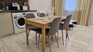 A modern kitchen with a washing machine, a coffee maker, and a clock on the wall. - Quality&Design
Vitosha Blvd (Sofia)