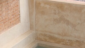 A spa area with a rectangular hot tub, terracotta pots with plants, and a tiled floor. - New Luxurious Boutique Riad 4bdr Private house (Marrakech)