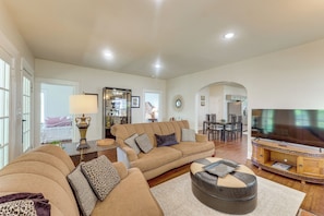 A spacious living room with a large sofa set, a coffee table, and a television. - Walk to Amphitheater, Bjcc & Stadium: 1920s Gem! (Birmingham)