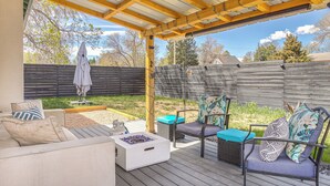A covered outdoor patio with a wooden deck, outdoor furniture, and a fire pit. - 2 Mi to Cherry Creek Trail! Family Home w/ Patio (Denver)