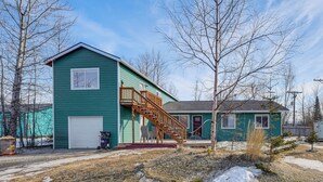 A green house with a wooden staircase leading to a porch. - Alaskan Adventure Base 2 Mi to Dtwn Wasilla (Wasilla)