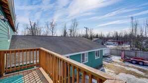 A wooden deck with a green house in the background. - Alaskan Adventure Base 2 Mi to Dtwn Wasilla (Wasilla)