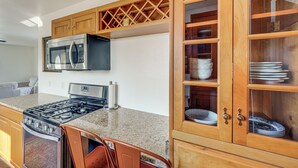 A kitchen with a gas stove, microwave, and wooden cabinets. - Alaskan Adventure Base 2 Mi to Dtwn Wasilla (Wasilla)