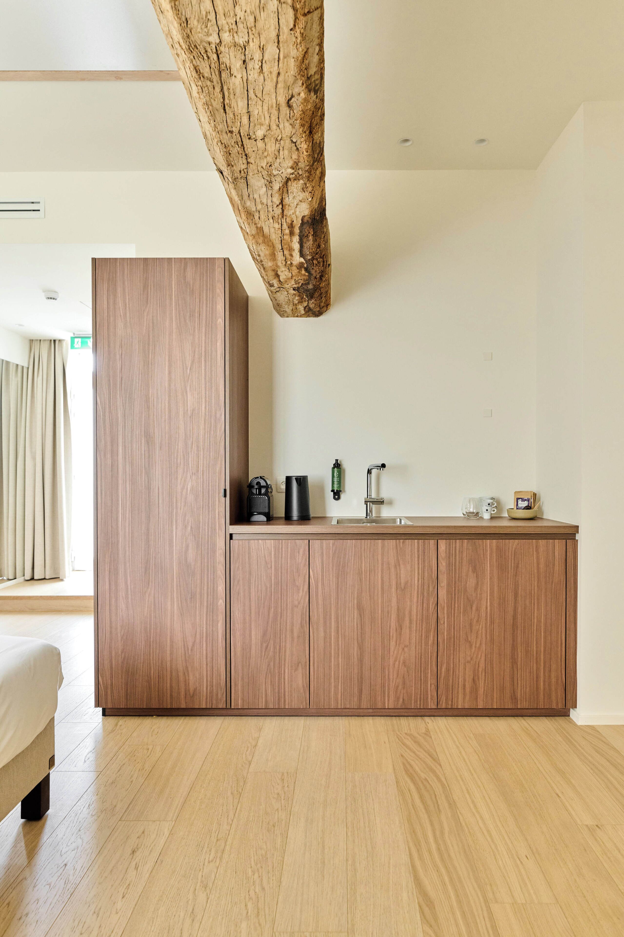 A modern kitchen with a wooden cabinet and a built-in sink.