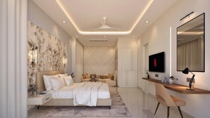 A modern bedroom with a bed, bedside tables, a desk, a chair, a TV, and a mirror.