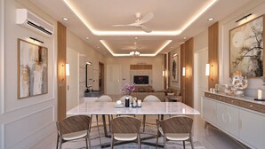 A modern dining area with a marble table, four chairs, and a patterned rug.