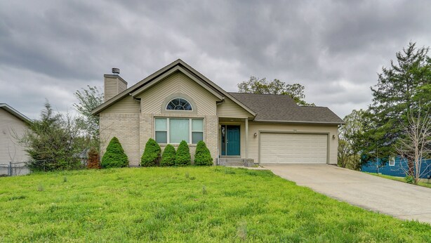 A residential house with a garage, a front lawn, and a driveway. - 4 Mi to Ha Ha Tonka State Park! Home w/ Deck (Camdenton)