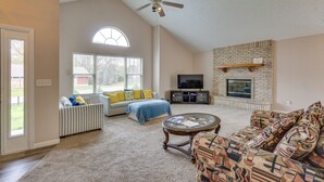 A living room with a sofa, a coffee table, a fireplace, and a television. - 4 Mi to Ha Ha Tonka State Park! Home w/ Deck (Camdenton)